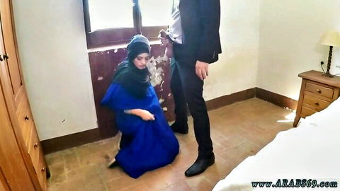 Arab Egyptian woman in hijab kneels for blowjob with suited man