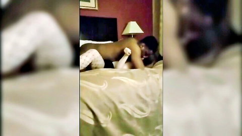 Interracial cuckold couple in intimate spooning embrace on bed