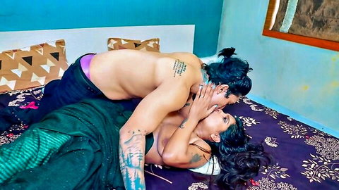 Beautiful Indian MILF in passionate kiss with tattooed lover