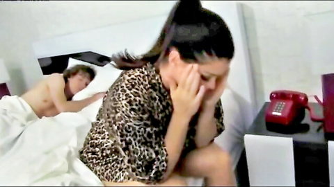 Busty MILF in leopard print covers face as naked stepson lies in bed