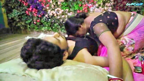 Naughty Indian cougar in saree leans over seductive pose with man