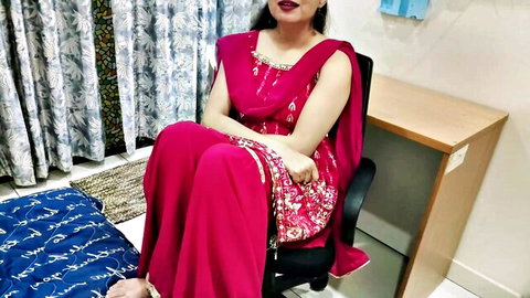 Desi bhabhi in red salwar kameez sitting seductively