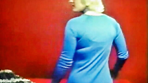 Vintage blonde in blue dress and black gloves, back view