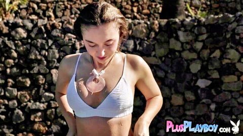 Brunette teen babe teasing small tits in sheer white crochet bikini top outdoors