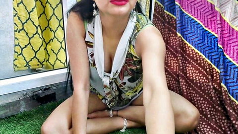 Indian beauty in floral low-cut top, teasing cleavage outdoors, Hindi style tease