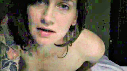 Bettie Bondage in bed for seductive bedtime story, topless with tattoos