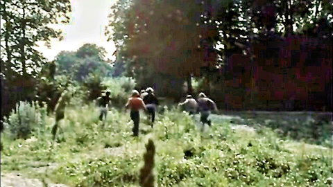 Vintage group of clothed teens running through tall grass in retro outdoor porn chase
