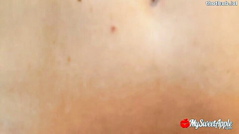 Blurry closeup of pale nude skin with hip curves and moles