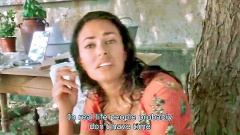 Emotional brunette woman in floral dress outdoors, The Second Wife 1998 scene