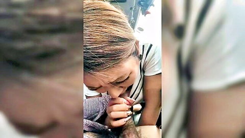 Asian woman giving intense blowjob in car, close-up oral action