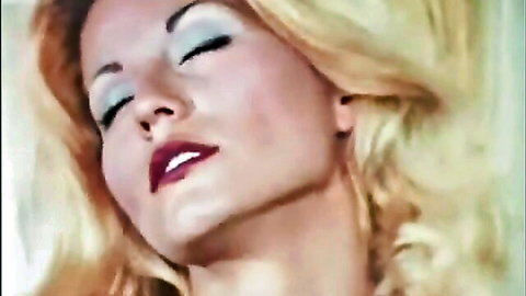 Vintage blonde Seka in seductive close-up with red lips and blue eyeshadow