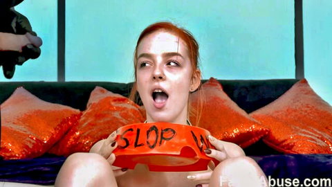 Redhead holds slop bowl, open mouth for cumshot in anal tears scene