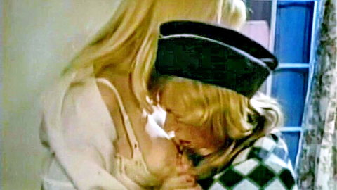 Blonde woman in black beret passionately kissing blonde partner in checkered shirt