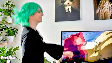 Tatsumaki cosplay with green wig in black dress posing before One Punch Man anime scene