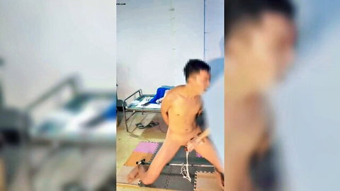 Nude Asian man in bound legs-spread pose, explicit solo exposure