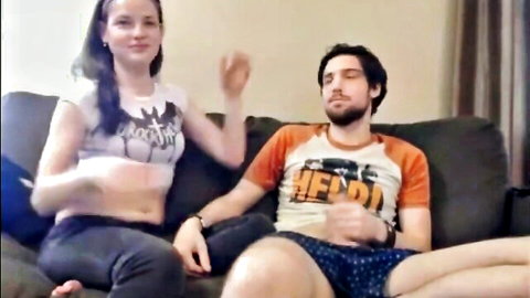 Young amateur stepsister in batgirl crop top teases boyfriend on living room couch