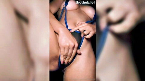 Christina Khalil in blue slinkini at pool, teasing with big tits and pussy reveal