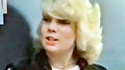 Vintage blonde woman in erotic interview, close-up with teasing smile