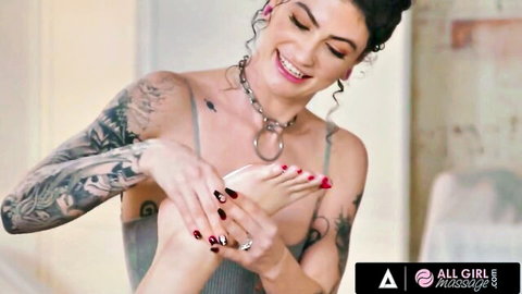 Tattooed brunette gives sensual foot massage to college girl in oiled lesbian scene