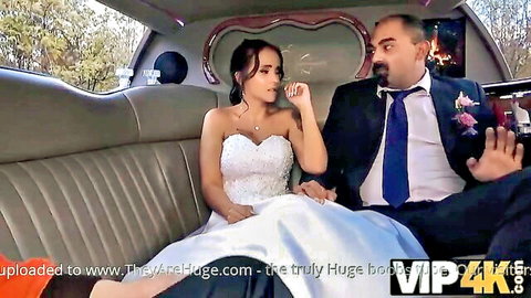 Busty Latina bride in white wedding dress with suited husband in limo