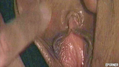 Close-up of curly dark-haired babe's wet pussy in old school style