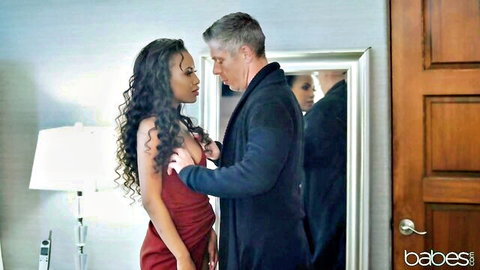 Demi Sutra in red dress embraces silver-haired man in steamy holiday tease
