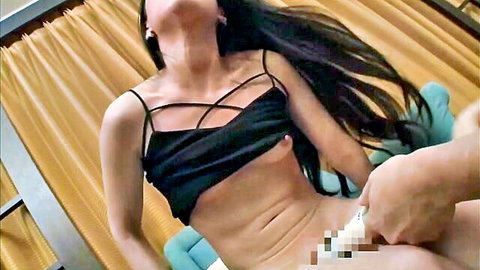 Asian woman with long black hair in ecstasy, black top exposing breasts, toy play on exposed body