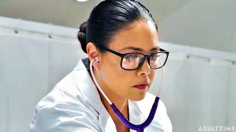 Sexy Asian female doctor in glasses, lab coat, and stethoscope in hospital