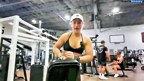 Muscular blonde woman in sports bra working out at Dallas gym