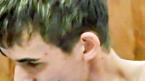Close-up of cute young man's profile with dyed hair in gay adult scene