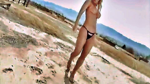 Blonde big-tits babe topless in black thong, dancing in desert music video