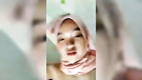 Asian hijab girl wet tease in shower, close-up face