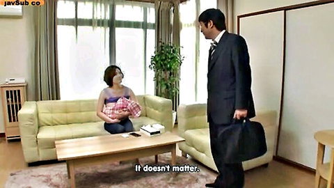 Japanese woman holding baby meets suited man in cozy living room
