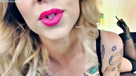 Miss London Lix seductive close-up with pink lips, blonde hair, tattoos
