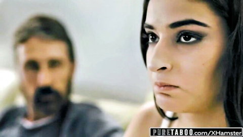 Emily Willis in taboo daddy scene, intense side gaze with bearded man