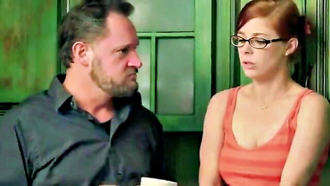 Redhead stepdaughter in tank top with glasses stares intently at bearded DILF stepdad in taboo daddy roleplay.