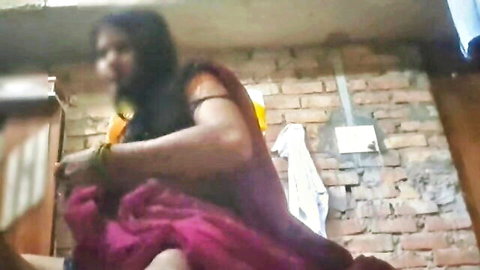 Indian Desi woman in pink sari sitting at home, homemade adult thumbnail