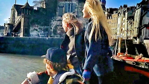 Vintage 1977 scene with blonde women and child on boat by river, Alpha France style
