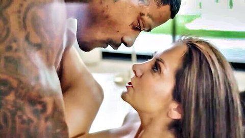 Busty cougar locked in intimate gaze with muscular black stud