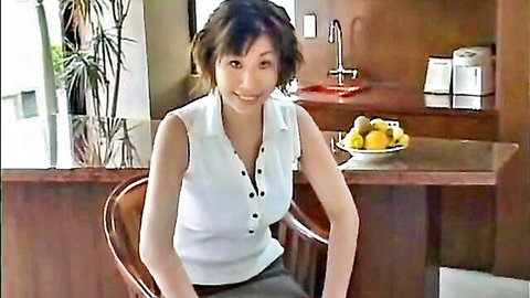 Smiling Asian woman in white buttoned blouse and skirt, teasing cleavage