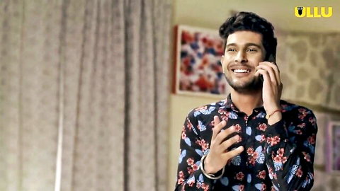 Handsome Indian man with curly hair and beard smiling on phone in Kaamwali Bai ep 2