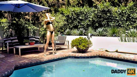 Sydney Cole in skimpy bikini posing seductively by the pool