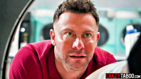 Intense handsome man in maroon shirt stares from laundromat window in taboo porn preview