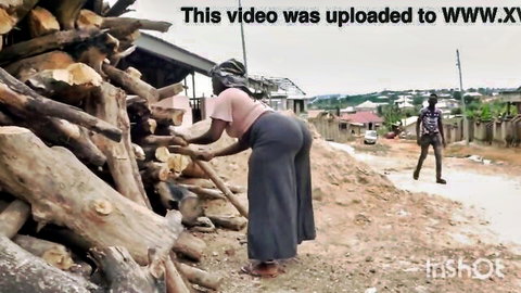 Ebony woman bending over in skirt, showing big ass while collecting wood outdoors