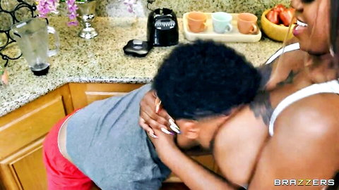 Thick ebony MILF pulls black stud's face deep into her massive cleavage in kitchen foreplay