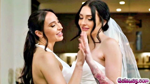 Annie and Charlotte in white wedding dresses, smiling intimately