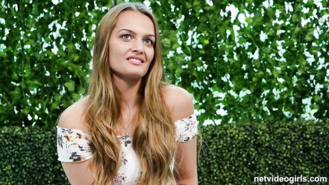 Seductive blonde in off-shoulder floral dress posing outdoors