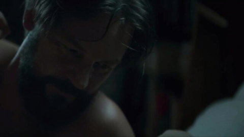 Bearded man close-up in intense scene from Broad Peak (2022) with Maja Ostaszewska