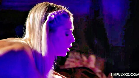 Blonde beauty nude in seductive side profile under purple lights
