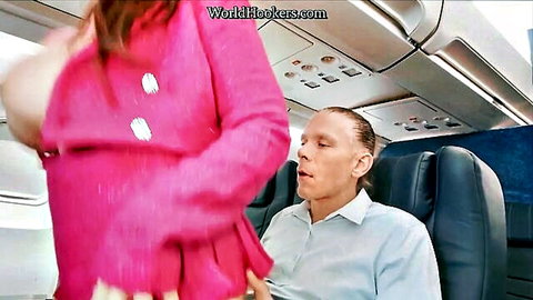 Busty redhead flashes huge tits to man in airplane seat